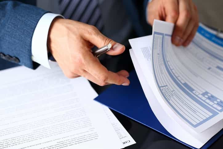 Businessman reviewing shipping documentation forms