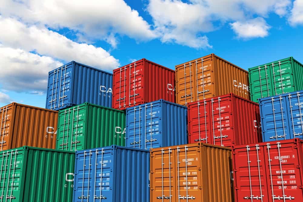 Colorful stacked shipping containers under a blue sky