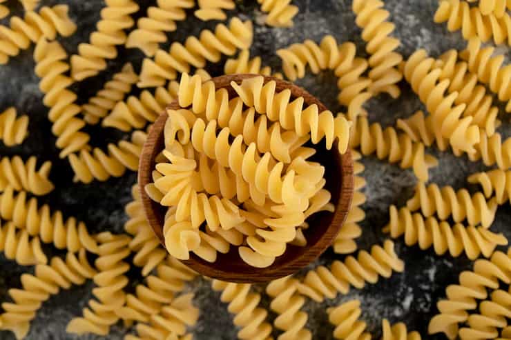 Pasta corta en espiral servida en un bol de madera